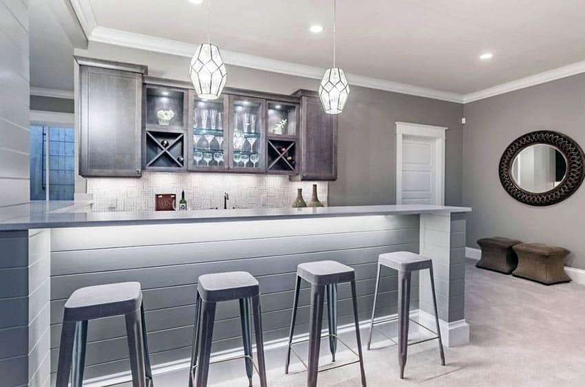 Shiplap home bar with bar stools and stained cabinets