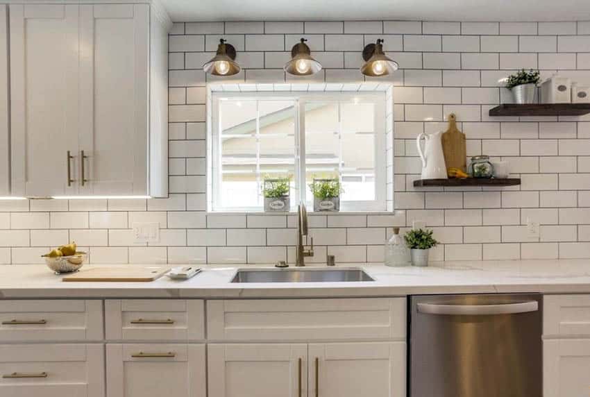 Single wall kitchen with eggwhite tile backsplash and floating shelves
