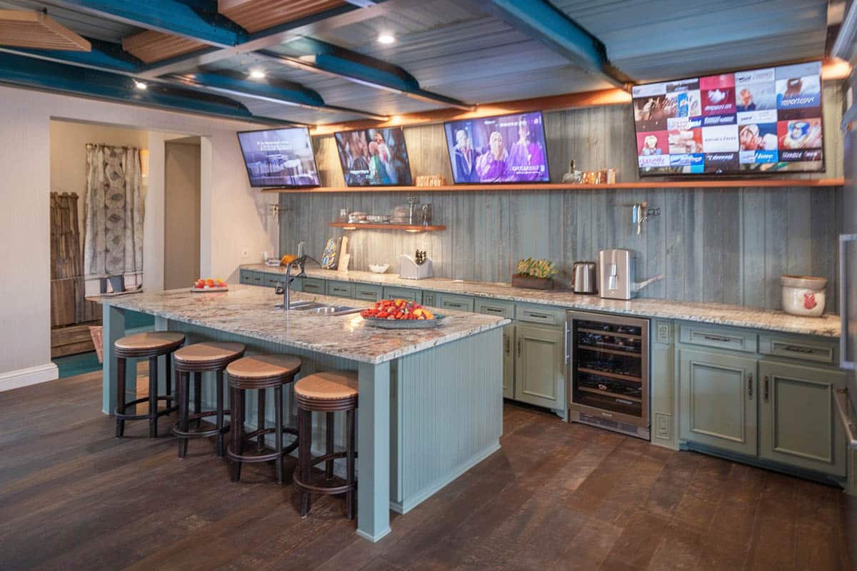Basement with stone countertops and white walls with gray wainscoting