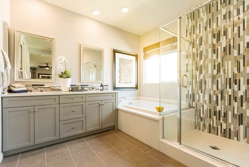 Bathroom with light yellow paint, alcove tub and mosaic tile shower
