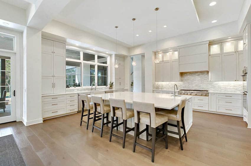Beautiful open concept kitchen with white cabinets and white quartz countertops