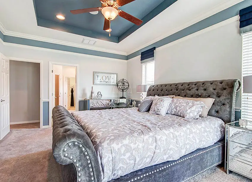 Bedroom with blue painted tray ceiling and white border