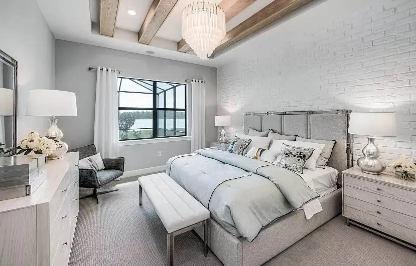 Bedroom with tray ceiling and faux wood beams