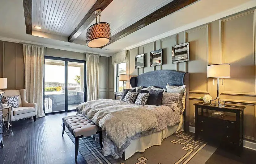 Bedroom with tray ceiling with shiplap and wood beams