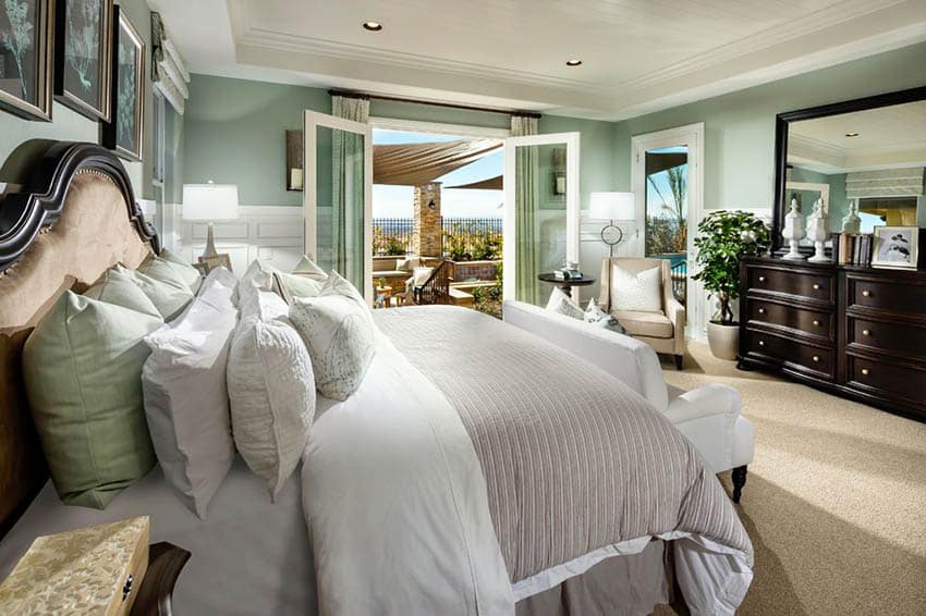 Coastal bedroom with seafoam green paint and white wainscoting