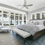 Contemporary master bedroom with hardwood look laminate flooring