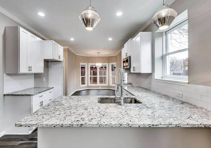 Contemporary kitchen with Dallas white granite countertops and white shaker cabinets