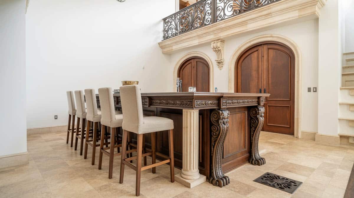 Bar with a neo-classical column island, carved wood details, and a lowered ceiling design