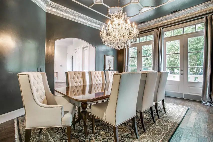 Formal dining room with black walls decorative tin tray ceiling with chandelier