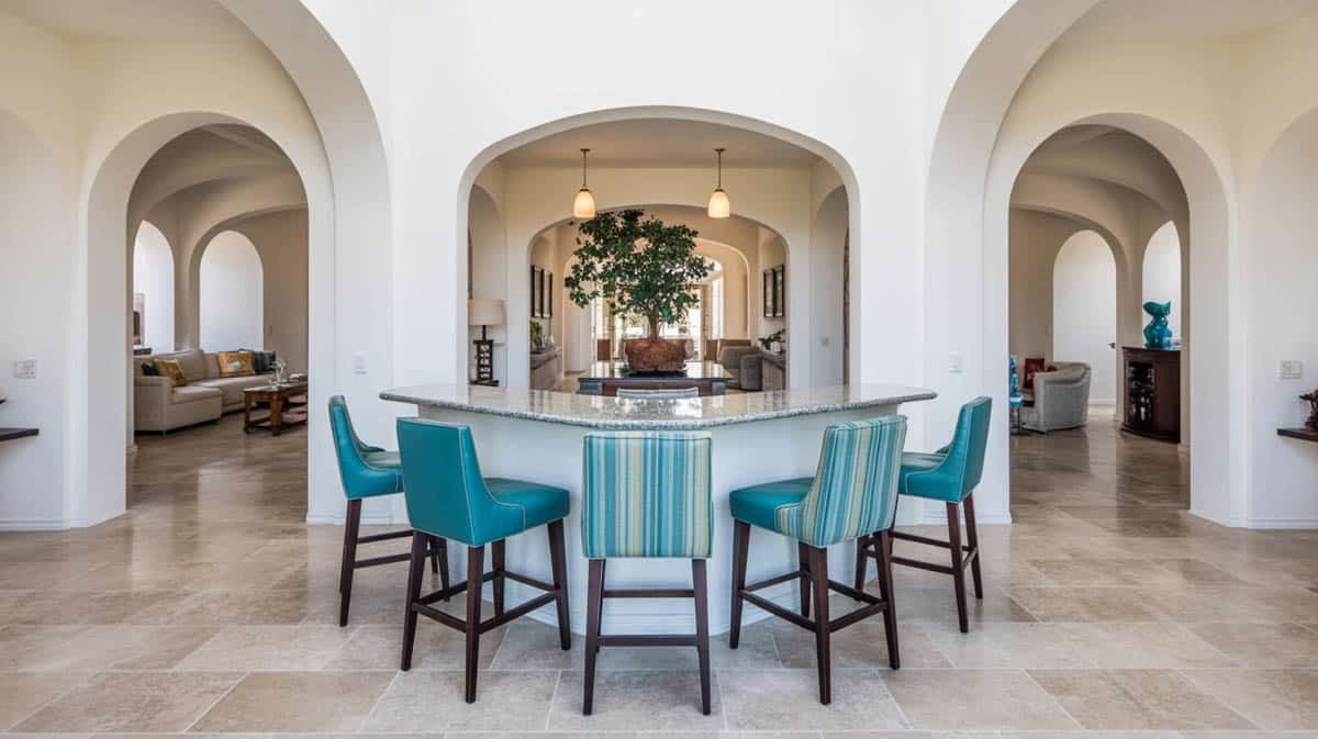 Bar integrated into a living space with stone surfaces, limestone floors, and warm white lighting