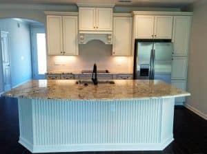 Kitchen With Cream Cabinets And Large Beadboard Island 300x224 