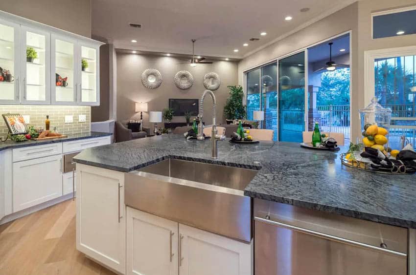 Kitchen with honed soapstone cabinets and white shaker cabinets