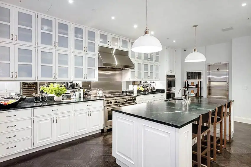 Kitchen with white cabinets and dark green soapstone countertops