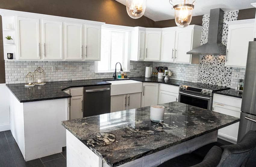 Kitchen with white cabinets, dark granite countertops, tile backsplash and brown wall paint