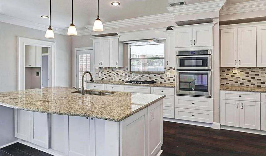 Kitchen with white cabinets and yellow granite countertops
