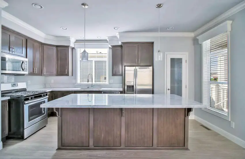 Kitchen with tan cabinets and greige wall