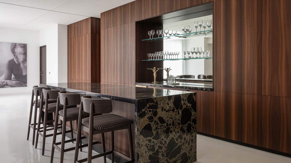 Bar with dark marble countertop paired with bold stools and art installations