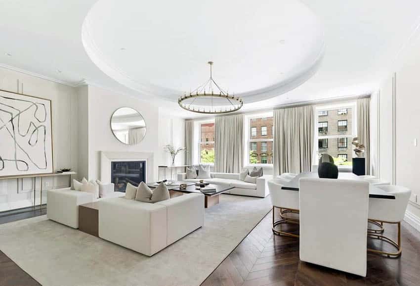 Open concept living room with round tray ceiling and circular chandelier