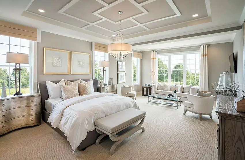 Master bedroom with geometric design tray ceiling with drum chandelier