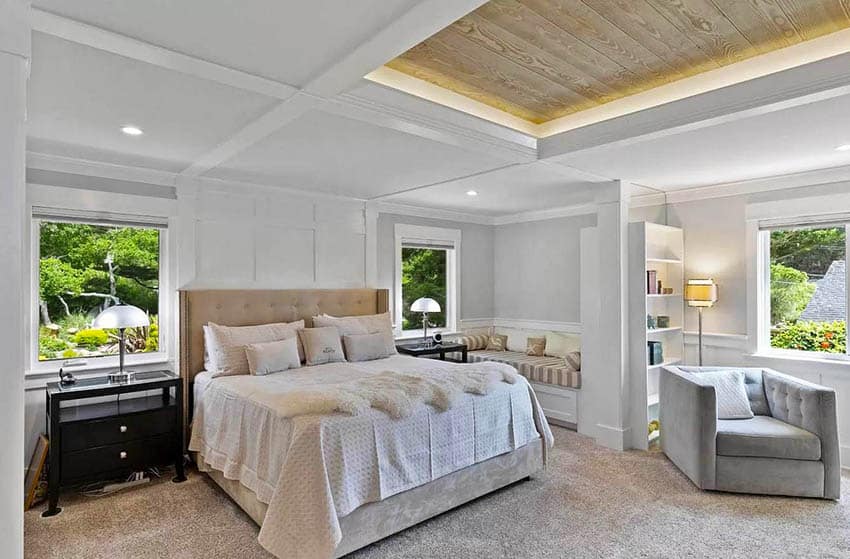 Master bedroom with wood plank tray ceiling with backlights built in bench window seat