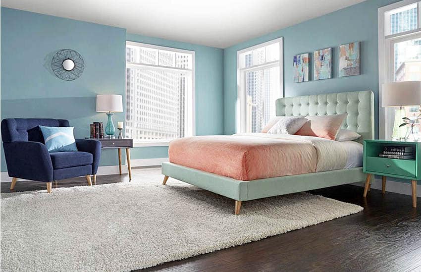 Mid-century modern bedroom in light blues with light green bed