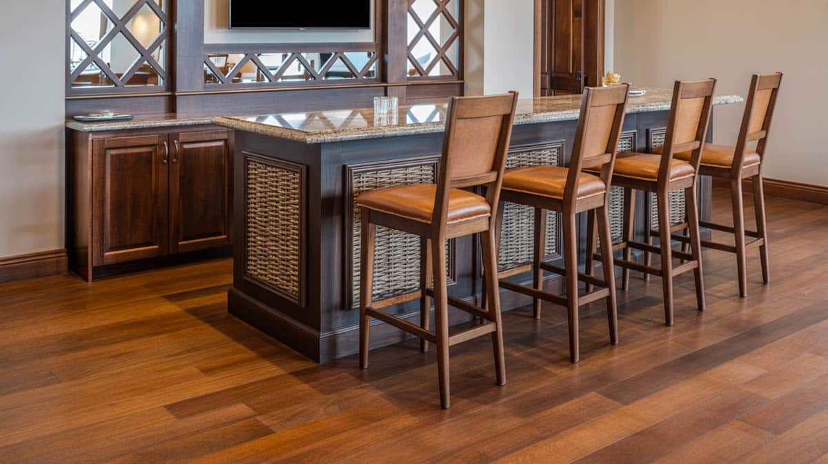 Bar with varied-grain wood floors, granite counters, and industrial-style décor