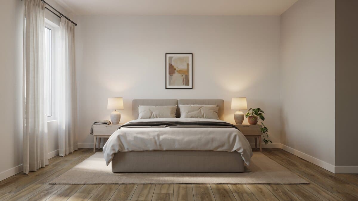 Modern bedroom featuring wood-look laminate flooring with a gray upholstered bed