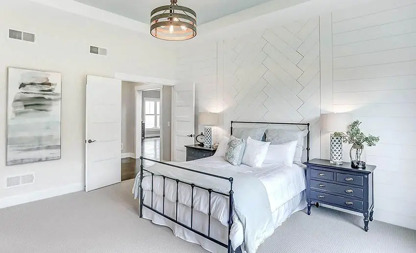 Modern farmhouse bedroom with shiplap walls and hoop light fixture