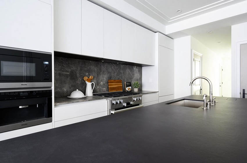 modern white kitchen cabinets with black countertops