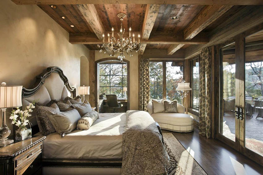 Old world traditional master bedroom with french doors, hardwood flooring and chandelier