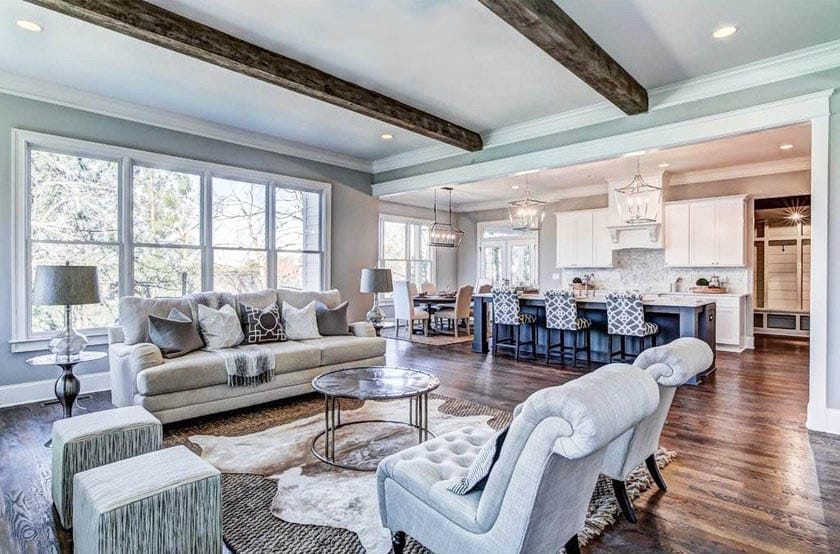 Open concept living room with white cabinet kitchen with blue island