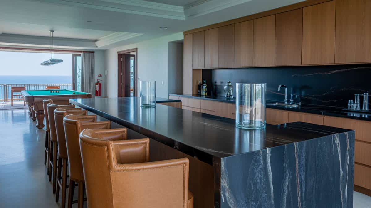 Modern bar with a black marble waterfall countertop and wood veneer cabinetry