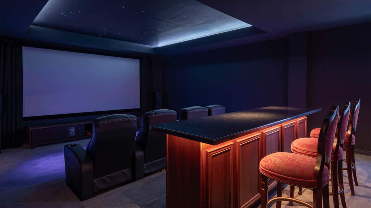 Bar built into a home theater room with a smart dual-purpose layout