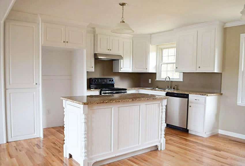 Kitchen with mdf cabinets and narrow island with turned column design