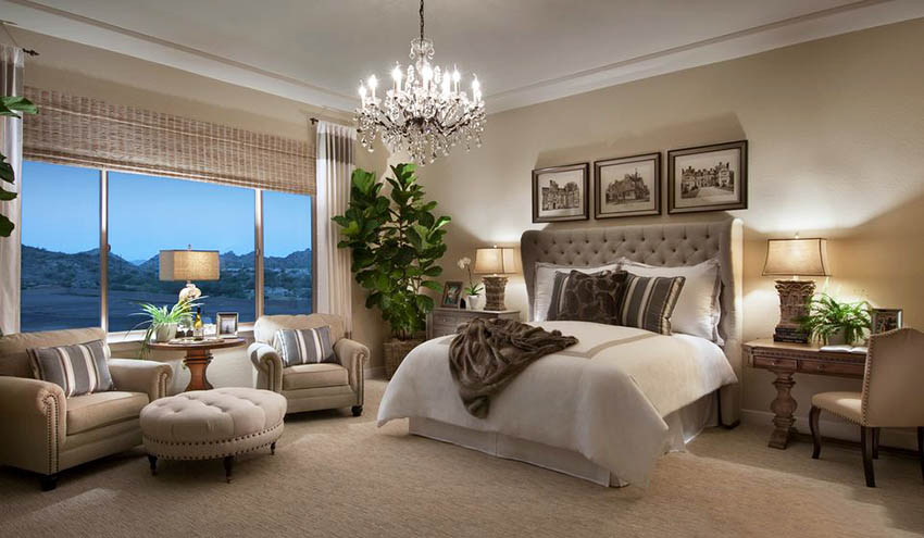 Traditional master bedroom with crown molding carpet and chandelier