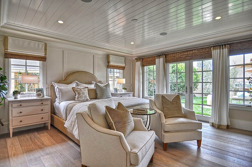Master bedroom with light maple flooring and white shiplap ceiling