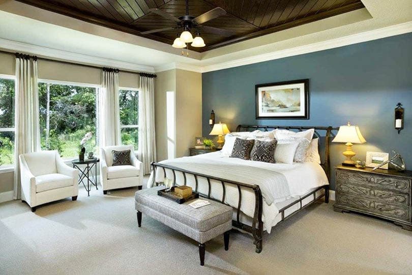 Traditional master bedroom with wood plank tray ceiling and blue accent wall