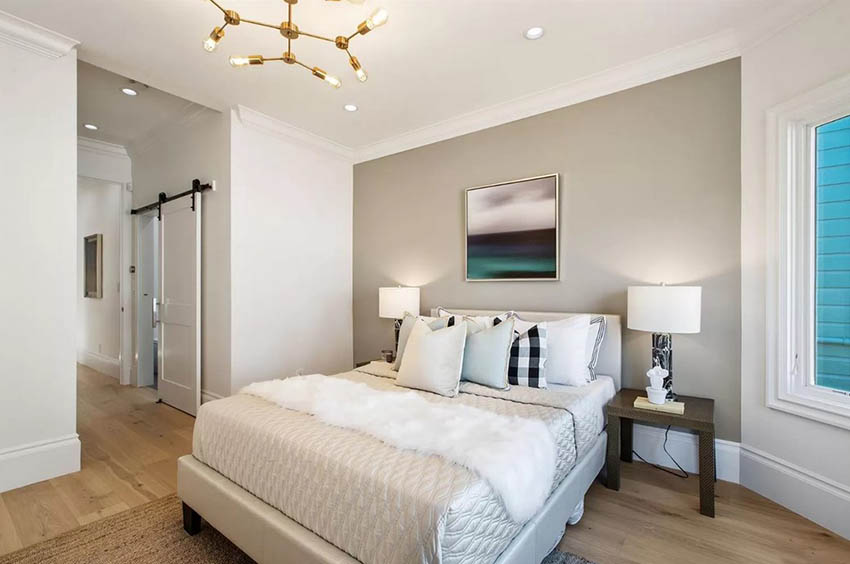 Bedroom with table lamps recessed lighting and modern sputnik style chandelier