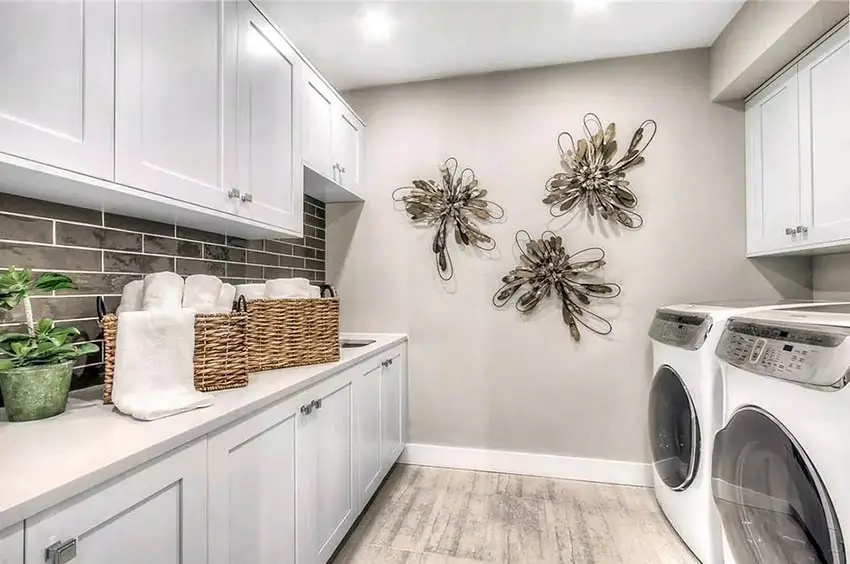 Finished basement laundry room with white cabinets wood look tile floor