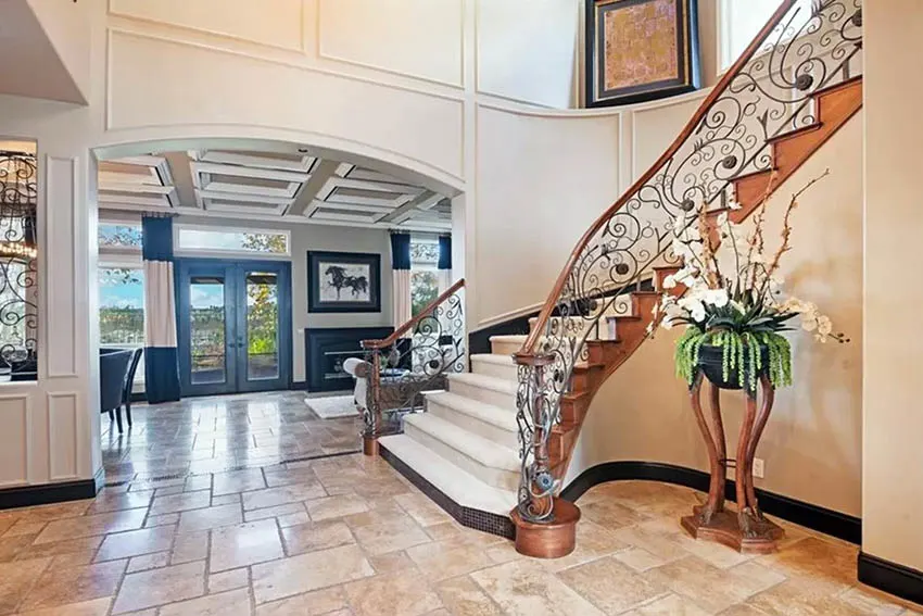 Foyer staircase with large indoor plant arrangement