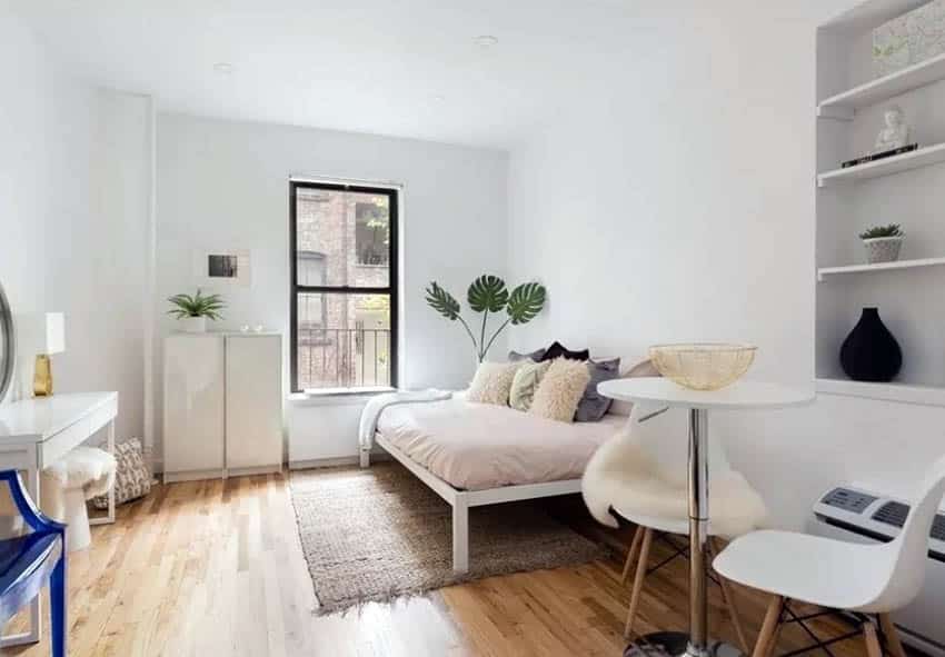 Guest bedroom with inset wall with shelving and decor