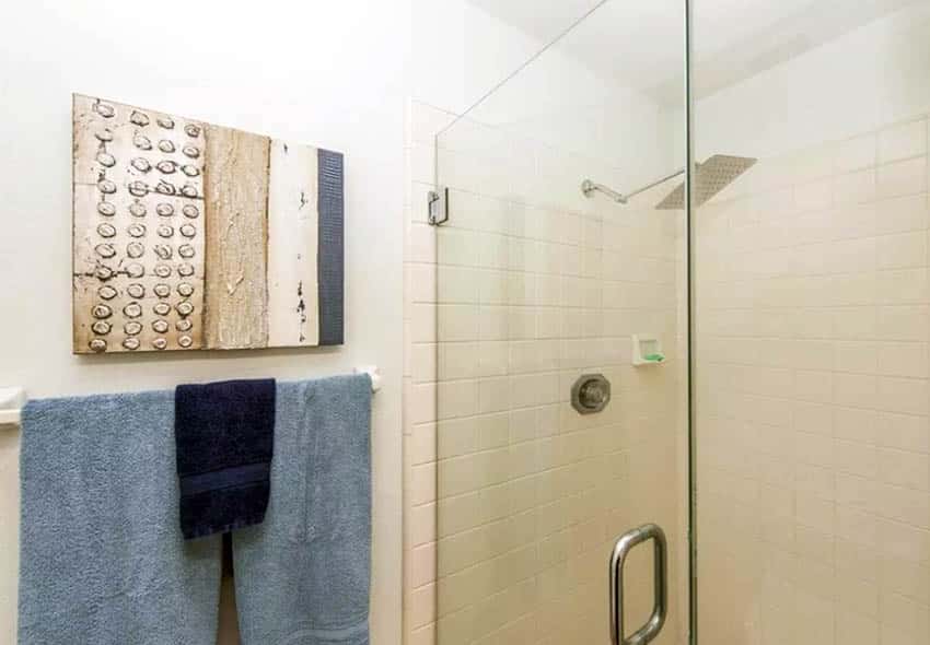 Hang picture above towel bar in bathroom
