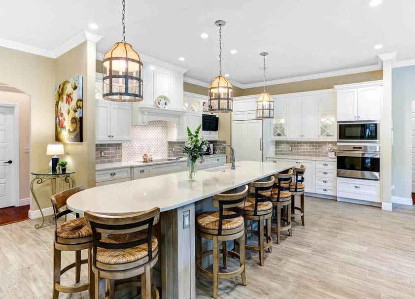 Kitchen with circular island breakfast bar distressed wood and white cabinetry