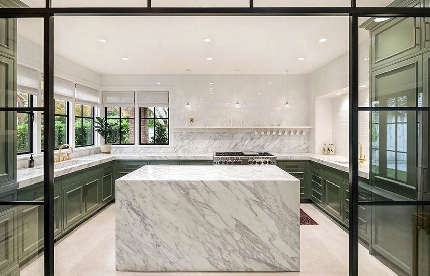 Kitchen with quartz waterfall countertop island and green cabinets