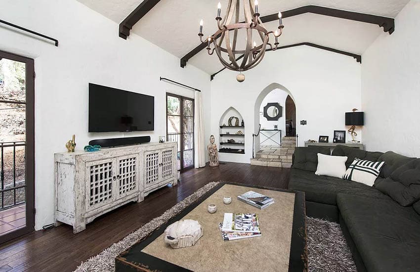 Spanish style room with architectural recess and beam ceiling