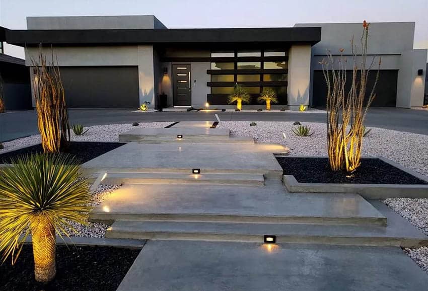 Modern home with desert landscape lighting