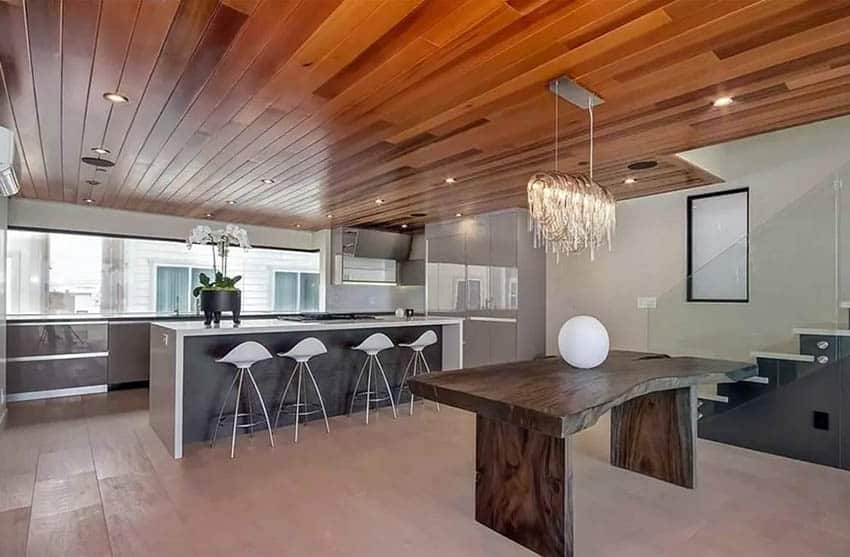 Open concept kitchen and dining room with wood tongue and groove ceiling