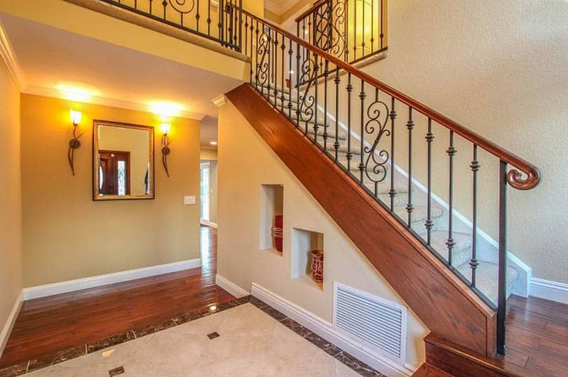 Staircase with cutout wall opening and decor vases