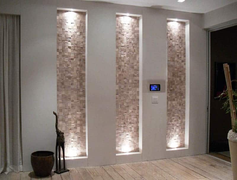 Tall recessed wall niche with stone accent and lighting in entryway