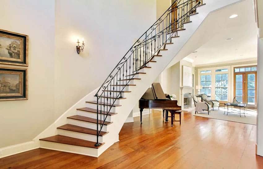 Grand piano in living room under staircase